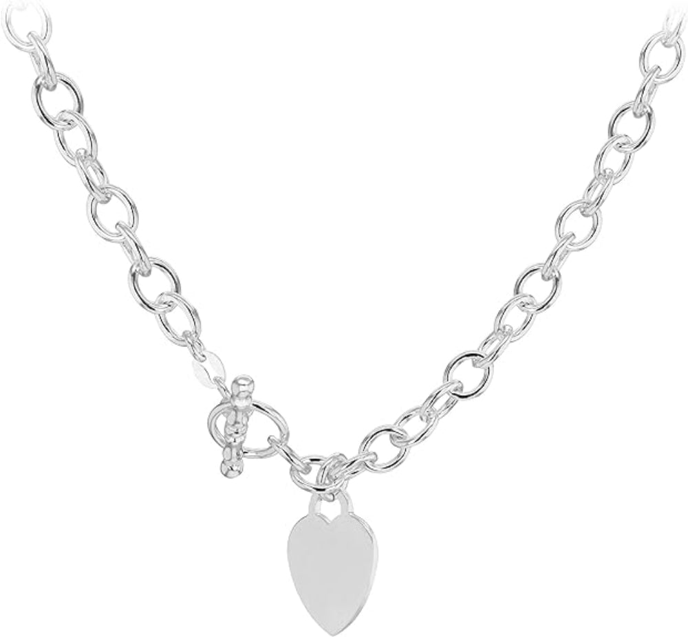 A silver chain necklace featuring a polished heart-shaped pendant and a small key charm, displayed on a clean white background.