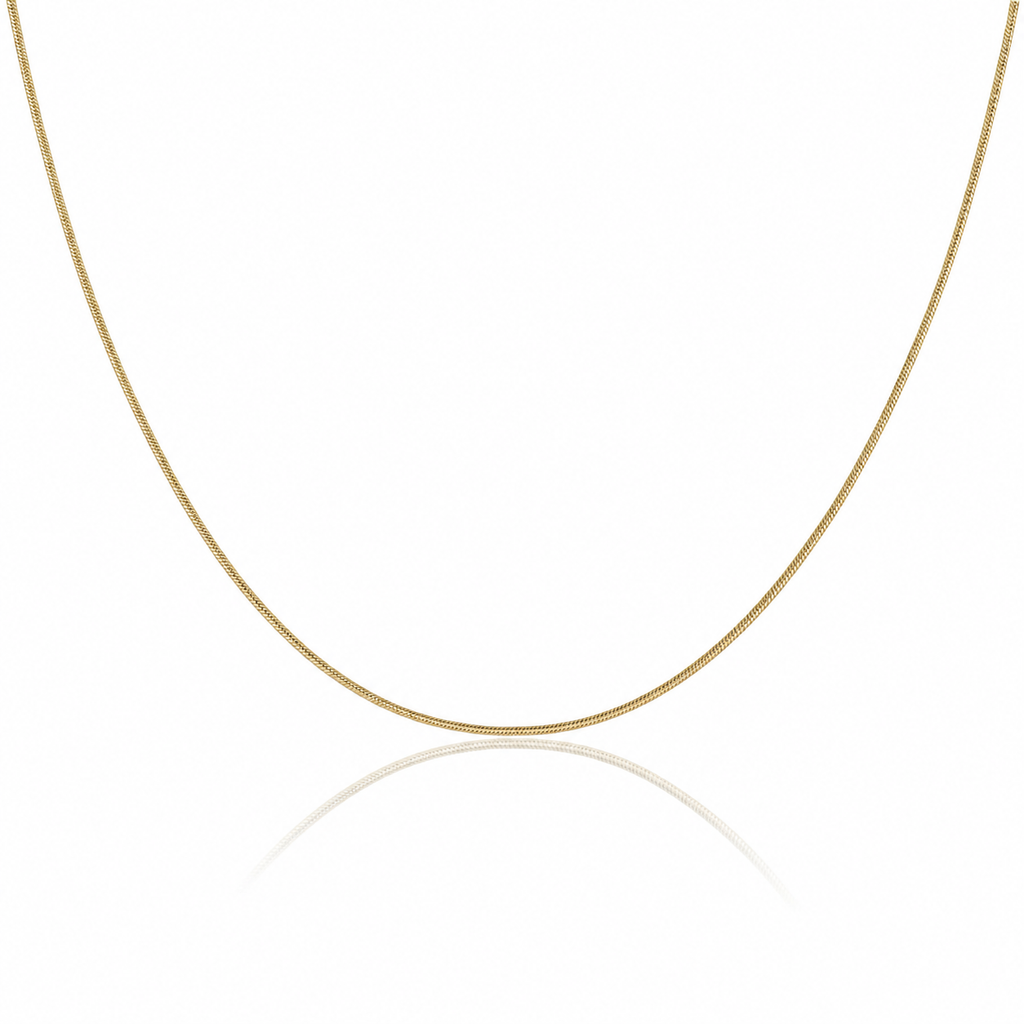 A delicate yellow gold chain necklace forming a U-shape against a clean white background with a soft reflection below.