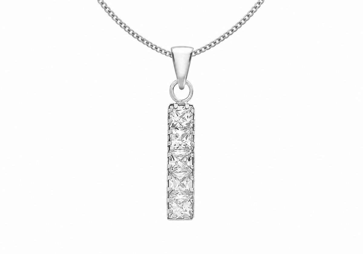 A silver-toned necklace featuring a vertical rectangular pendant set with a row of princess-cut clear stones, suspended from a matching chain against a plain white background.
