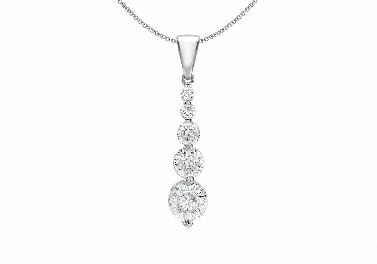 A silver pendant necklace featuring a vertical drop design with four graduated round-cut clear gemstones, suspended from a delicate silver chain against a plain white background.