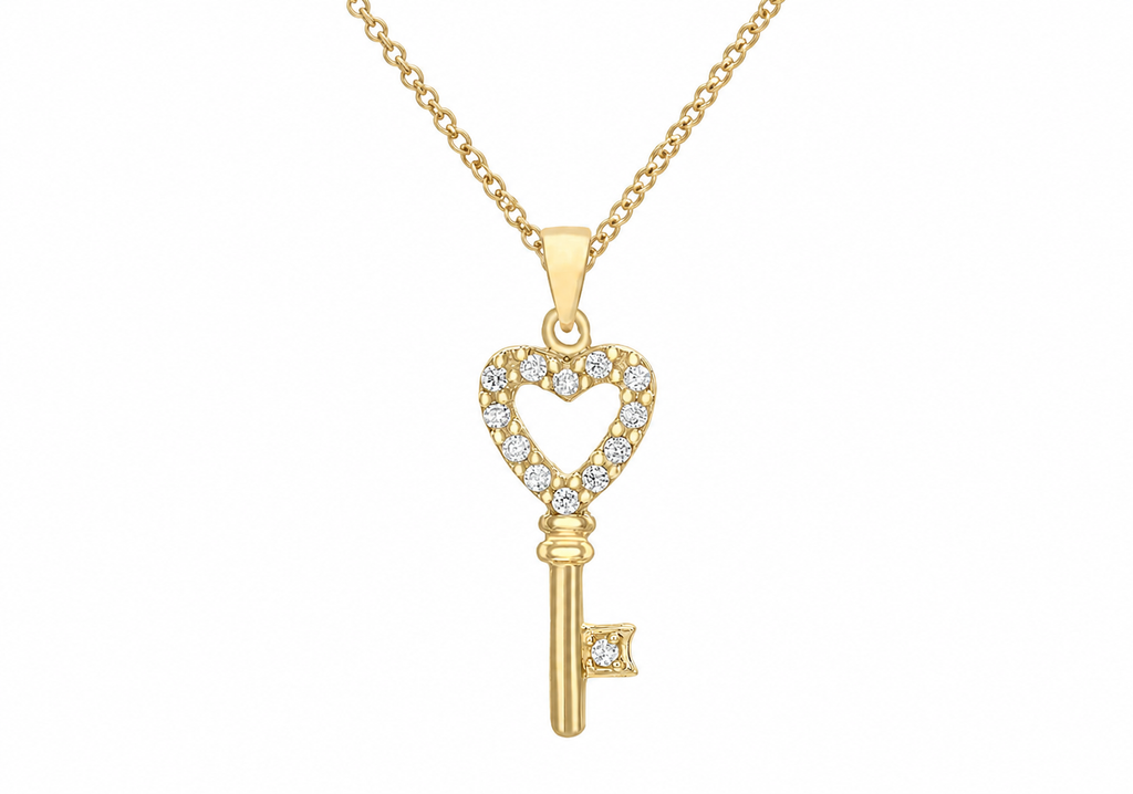 A gold key pendant necklace with a heart-shaped top adorned with small clear stones, shown on a white background.