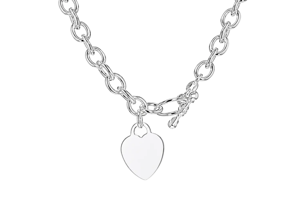 A silver-toned chain necklace with a small, polished heart-shaped pendant, displayed against a clean white background.