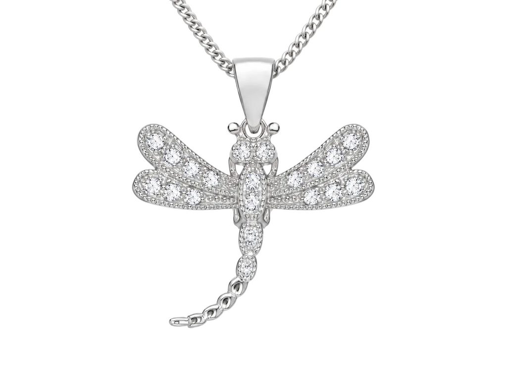 A silver dragonfly pendant necklace paved with small clear stones, hanging from a silver curb chain against a light gray background.