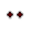A pair of clover-shaped stud earrings featuring deep red enamel centers surrounded by a border of small clear stones in a silver-tone setting, shown on a plain white background