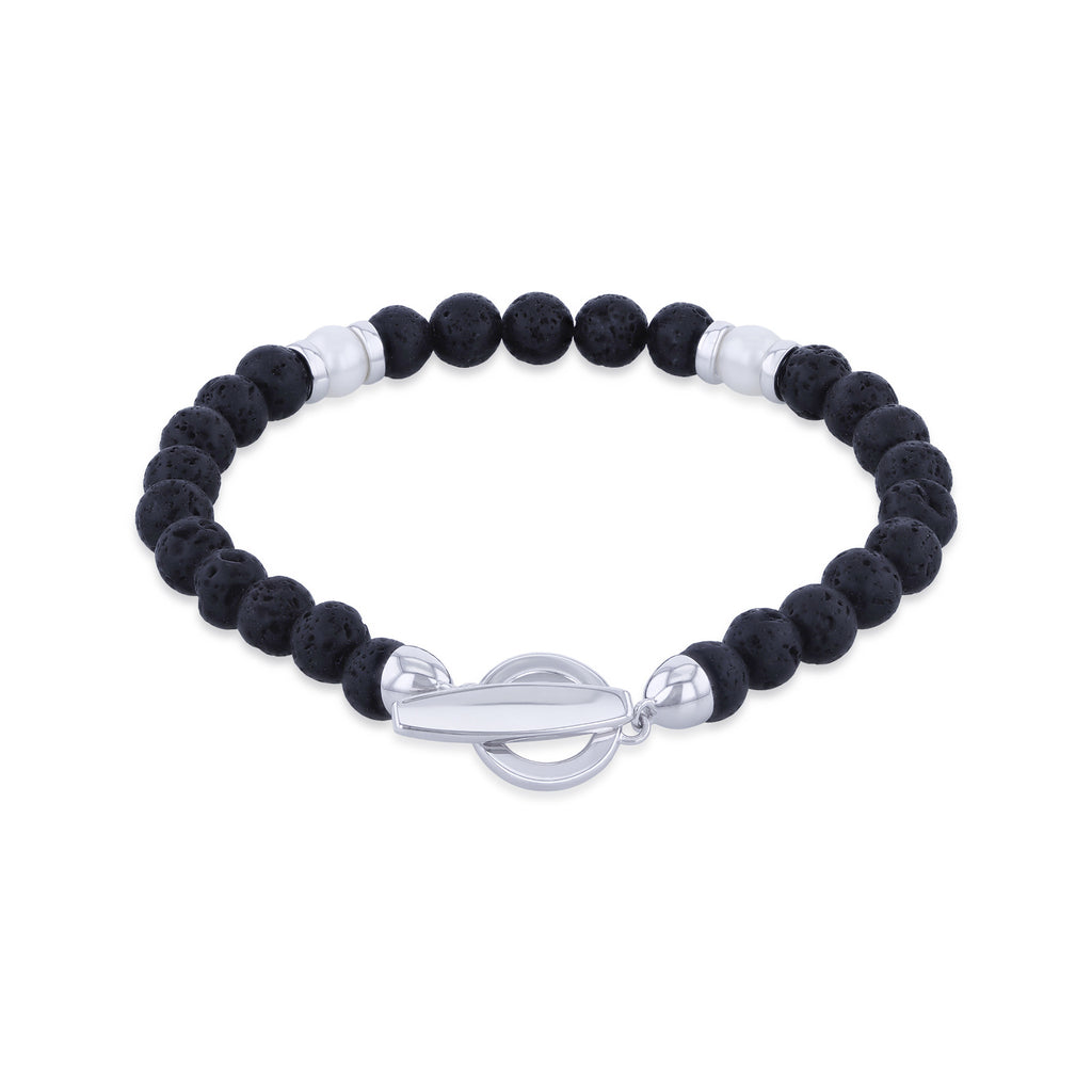 A beaded stretch bracelet featuring textured black lava stones and polished silver metal accents, including a toggle clasp, displayed on a clean white background.