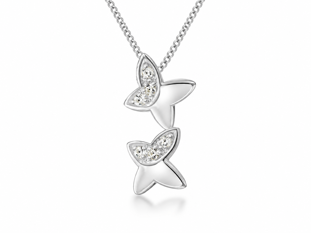 A silver pendant necklace featuring two stacked butterfly charms, each adorned with small clear crystals on one wing, suspended from a delicate silver chain against a white background.